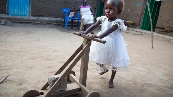 Little Girl Pushing Toy
