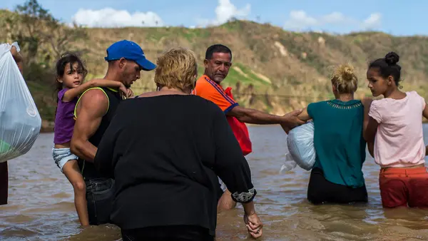 People Wading Through Water