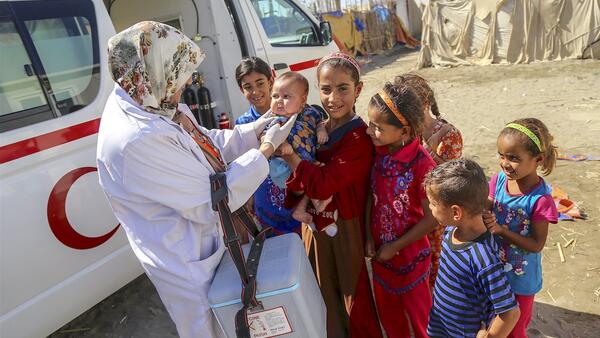 Children Gather Around Aid