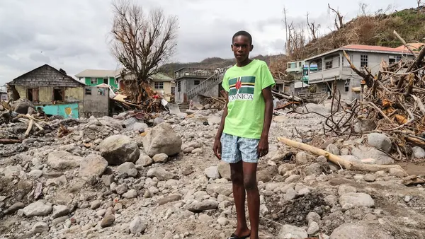 Child Surrounded by Rocks and Rubble