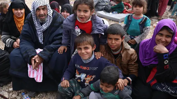 A newly displaced family from Mosul, Iraq arrive at Hamam al-Alil camp with very little luggage, unprepared to cope with the winter weather. 