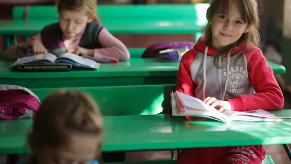A girl reads during a class in School No. 6 in Yasinovataya, Donetsk region, Ukraine, 24 October 2016.