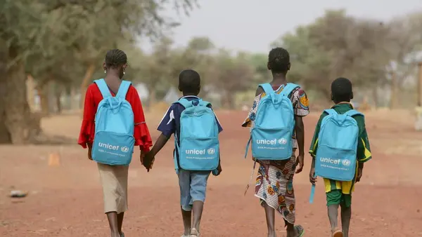 Children on their way home after a day in a child-friendly school in Mougna, Dienne District, central Mali. UNICEF provides each student with a blue backpack filled with school supplies like pens, pencils and rulers.