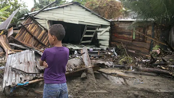 On September 7, 2017 in Boba, Nagua, a boy, 7, stands in front of debris as Hurricane Irma moves off from the northern coast of the Dominican Republic.