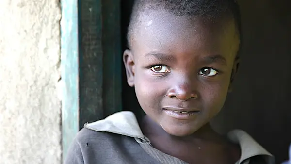Child Smiling in a Doorway