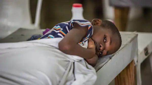 Child Laying Down with Blanket