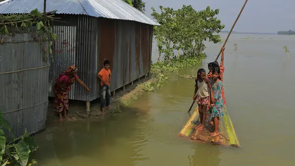 shot of girls in floodwaters in Bangladesh