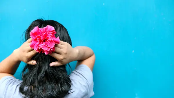 Girl Facing a Wall With Hands Behind Head