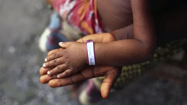 Child Hand on Top of Adult Hand