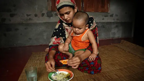 Mother Feeding Child