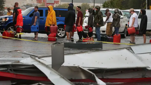 People with Gas Cans Waiting in Line