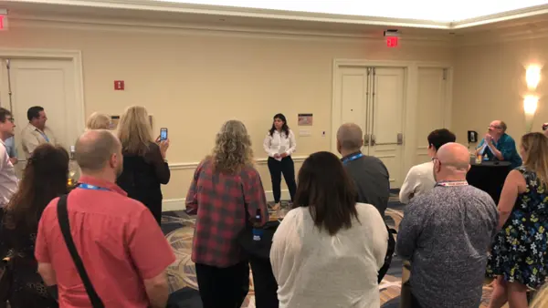 Person Speaking to a Room Full of Onlookers