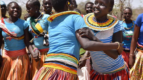 Adolescent girls and women from Ausikioyon village in Amudat District, Uganda celebrate after their village made a public declaration against Female Genital Mutilation (FGM).