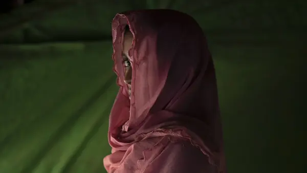 Girl Peering Out from Under Head scarf