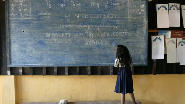 Child Writing on Blackboard