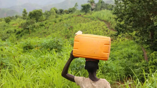 Liliane, 14, carries an empty container as she makes her way to collect safe drinking water in Mukerezi-Mpakaniro hill, Makamba Province, Burundi, January 2017.