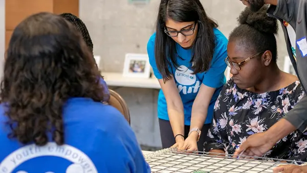 UNICEF Personnel Helping Child