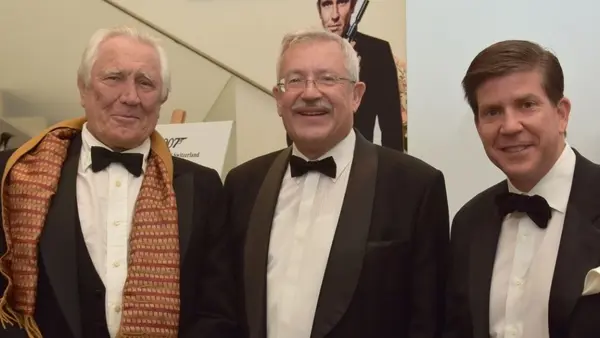 Three Men in Suits Smile at the Camera