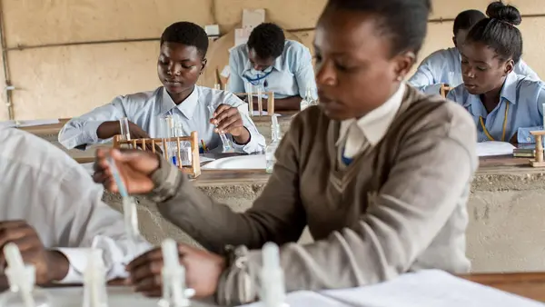 Adolescent girls conduct experiments during a chemistry at UNICEF-supported Kamulanga Secondary School in Lusaka, Zambia in 2016.