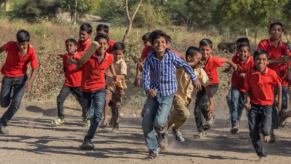 Primary school students in Aurangabad, Maharashtra state, India, after playing a cricket match organized by a UNICEF-supported program emphasizing social change through sport.