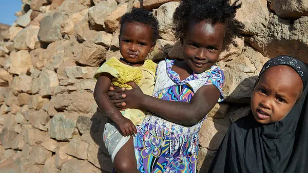 n February 2018, young girls stand outside their traditional stone home in the village of Assamo, Djibouti. 