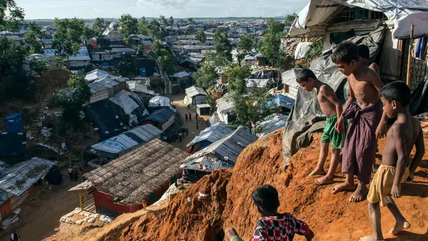 Rohingya refugee boys play on a muddy ridge in BaluKhali refugee camp in Cox's Bazar, Bangladesh in September 2018.