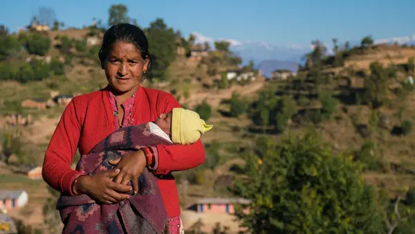 Janaki Odh with her 16-day old baby girl Nisha in Joshibunga, a village in Baitadi District, far western Nepal. Sixteen days before we captured this story, she gave birth to a baby girl, Nisha. She had a home delivery, but halfway through she noticed that