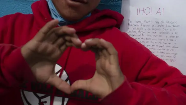 A boy reacts to a letter of support he received from a Mexican teenager at a shelter for unaccompanied migrant adolescents in Tijuana, Mexico in February 2019.