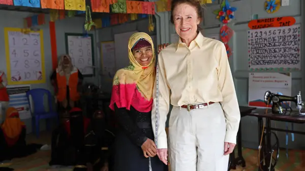 Sura, a young Rohingya refugee learning to make dresses, measures UNICEF Executive Director Henrietta H. Fore at a UNICEF-supported Adolescent Center in Cox's Bazar, Bangladesh.