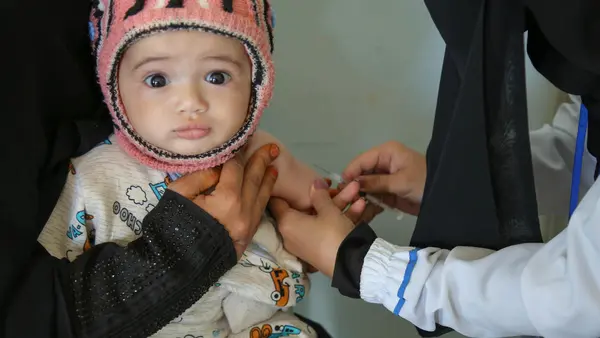 A child is vaccinated at a health center in Sana'a, Yemen during a UNICEF-backed measles and rubella vaccination campaign in 2019.