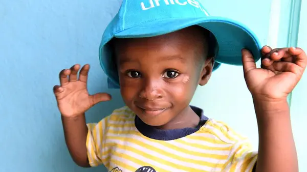 Israel, a 16 months old boy, is playing in the health center of Williamsville, where his pregnant mother came for a consultation.