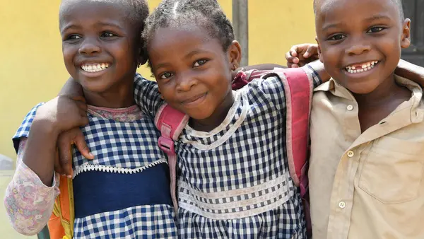 Happy friends leaving their UNICEF-supported school in Gonzagueville, a suburban of Abidjan, the capital of Côte d'Ivoire, in 2019.