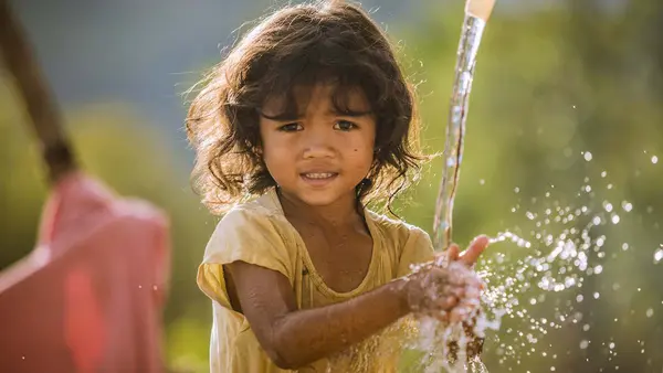 Pinang Thi Thuy, Raglai ethnic minority 5 years girl, enjoys her family's clean water source in Bac Ai, Phuoc Hoa, Ninh Thuan. Thuy's family was suffered great crop failure due to the historical drought in Viet Nam, 2015-2016. In addition her younger brot