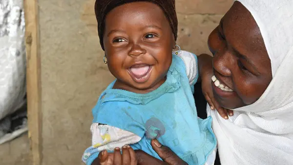 In March 2019, a mother cuddles her little girl in the village of Alibeit in southern Chad.