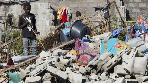On 24 March 2019 in Mozambique, a boy stands near a destroyed house in an area that was flooded after Cyclone Idai made landfall in Beira.