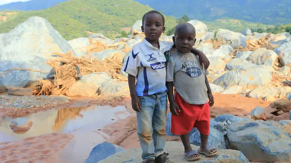 Brothers Anesu (left) and Future near the spot where their house was swept away when Cyclone Idai hit Zimbabwe in March 2019. 