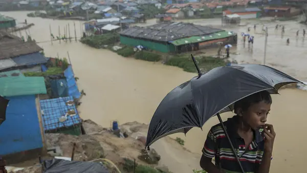 Nine-year-old Mohamed looks out over one of the canals running through Kutapalong refugee camp in Cox's Bazar, Bangladesh on July 6, 2019. Two bridges nearby were swept away by heavy monsoon rains. 