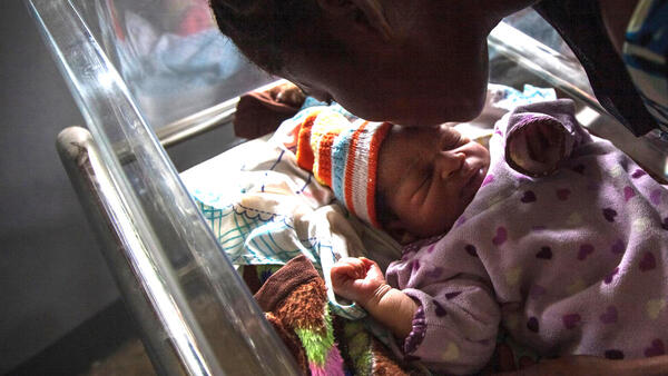 Akosusu Siska kisses her one day old baby, Reagen, in the UNICEF-supported Jules Chevalier clinic in Mbandaka, Équateur Province, the Democratic Republic of the Congo (DRC).