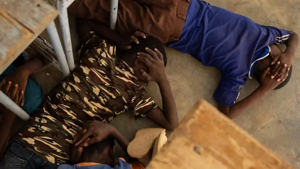 On June 26, 2019, children take part in an emergency attack simulation at the Yalgho Primary School in Dori, Burkina Faso.