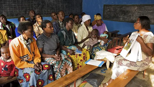 A UNICEF-supported female facilitator leads a Circle of Dialogue to discuss important social issues like health, hygiene, sanitation and HIV prevention at a church in the village of Rwaza in Musanze district, northern Rwanda. 