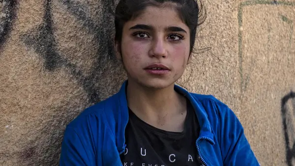 A Syrian girl cries upon her arrival in Hassakeh city after fleeing Turkish bombardment on Syria's northeastern towns along the Turkish border on October 10, 2019. 