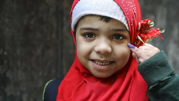 In January 2019, Aneesa, 5, shows the ink mark on her little finger that confirms she has received her polio vaccine from a UNICEF-supported vaccinator in the Bhatti gate area of Lahore Punjab Province, Pakistan. 