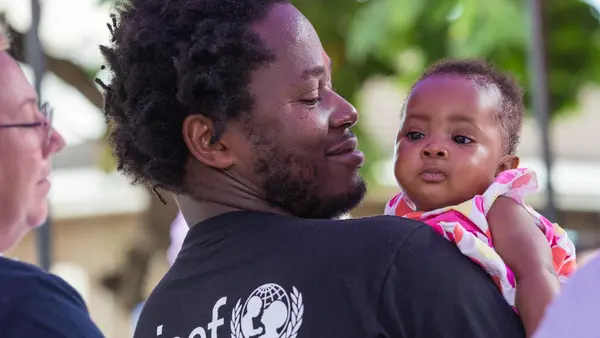 Ishmael Beah, author, former child soldier and UNICEF Advocate for Children Affected by War, holds a baby girl during a visit to Ola During Children's Hospital in Freetown, Sierra Leone, on 17 November 2019. 