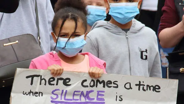 Girl Holding Up Sign