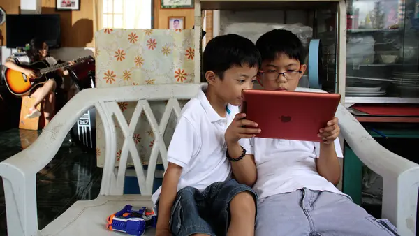 Two brothers photographed at home in Cebu, Philippines, where UNICEF works with partners to improve online safety for kids.