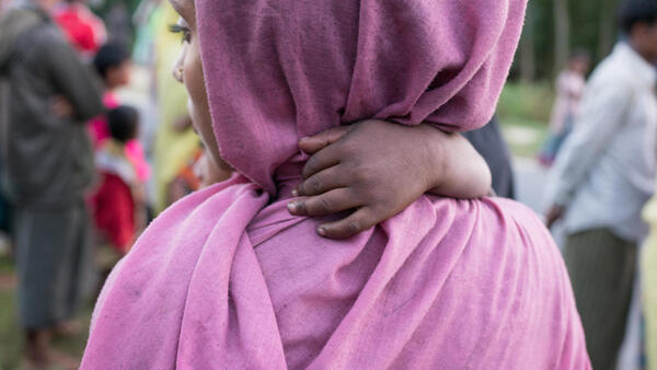 A Rohingya refugee mother and baby on the shores of Bangladesh after crossing by boat from Myanmar to escape genocidal violence.