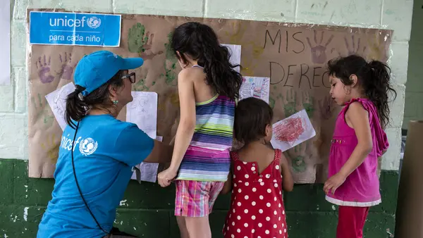 A UNICEF-supported Tech Palewi volunteer plays with children at the St. Augustine hotel for refugees and asylum seekers in Tapachula, Mexico, on January 30, 2019.