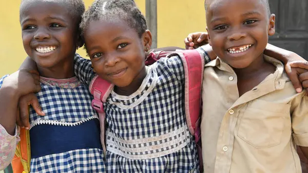 Happy friends leaving their school in Gonzagueville, a suburb of Abidjan, the capital of Côte d'Ivoire.