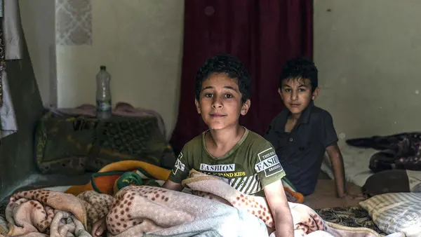 Brothers Ahmad (left), 10, and Abdullah, 9, and their family, refugees from Syria, are facing another frigid winter in Jordan. UNICEF emergency cash assistance and winter clothing kits will help them survive.