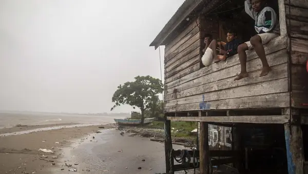 Children sit on a beach house window ledge as Hurricane Eta approaches in Bilwi, Puerto Cabezas, Nicaragua, on November 2, 2020. 